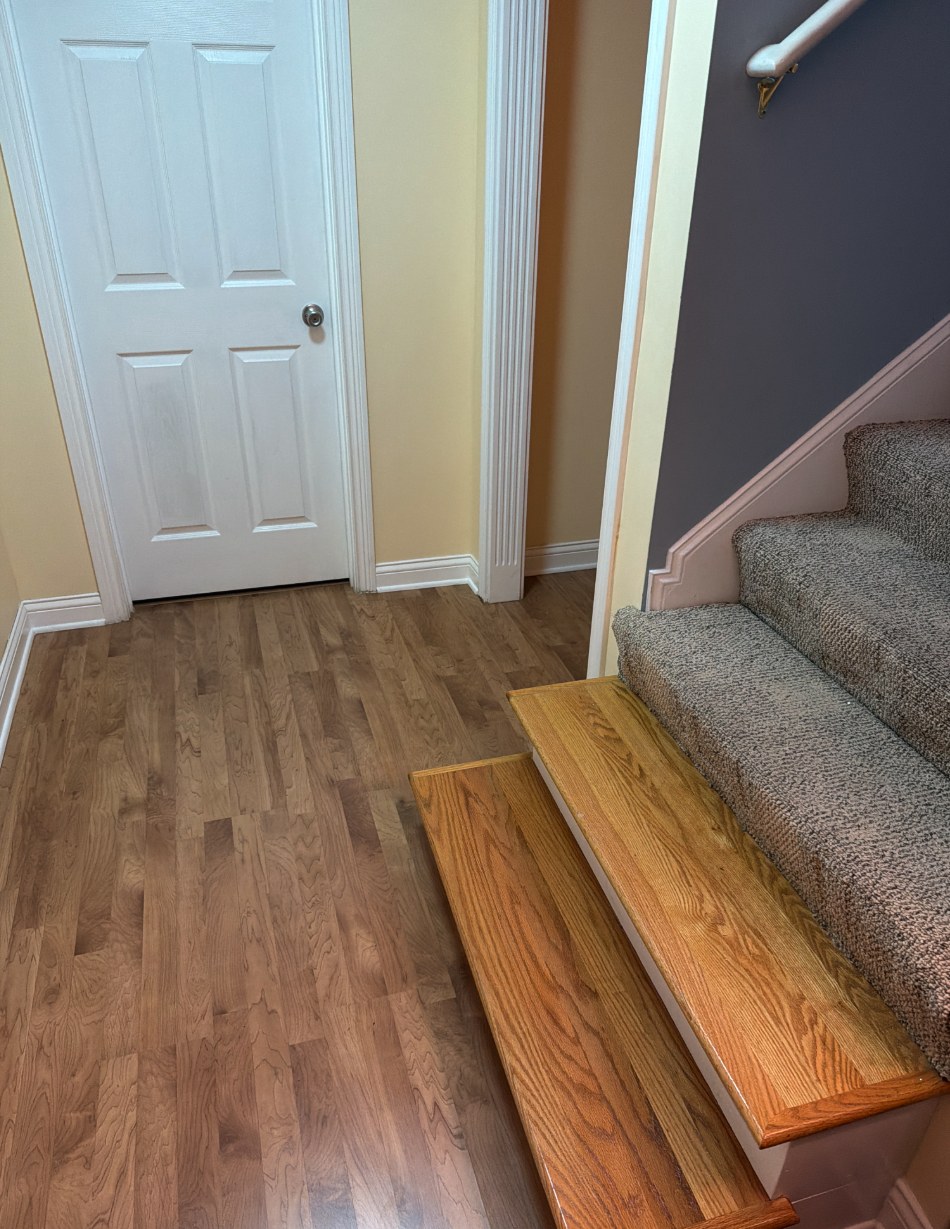 Finished basement with wood flooring in a Louisville home before water damage removal