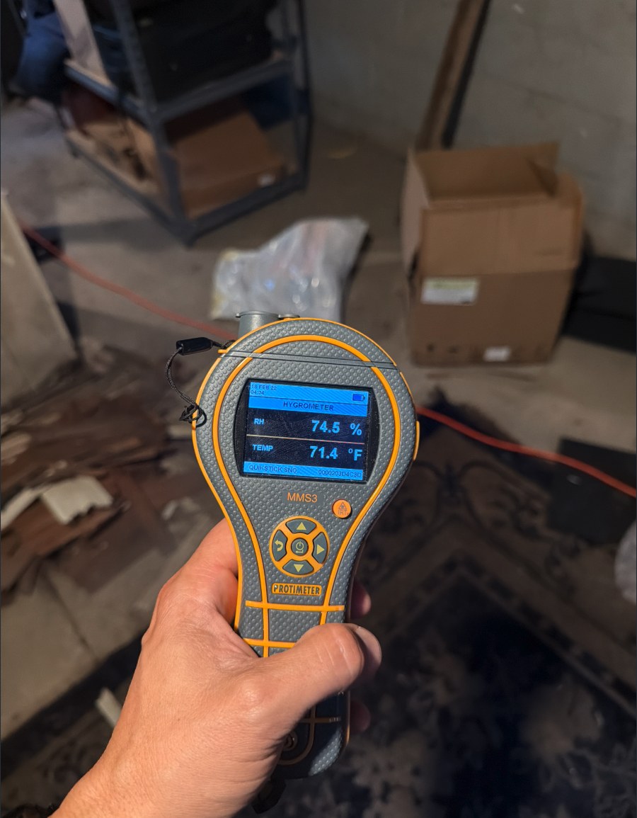 Protimeter hygrometer reading 74.5 percent relative humidity in a Louisville basement