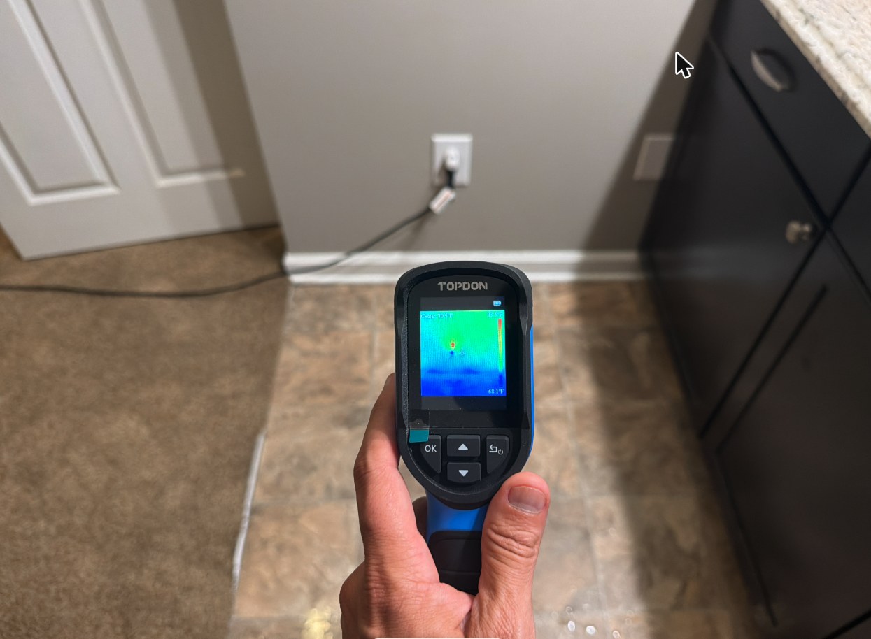 Thermal imaging camera showing a cold wet area behind a wall in a Louisville home